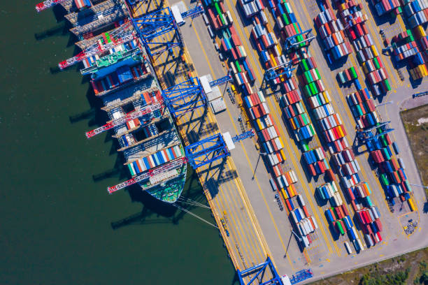 istock Container ship from sea port working for delivery containers shipment and container warehouse background. Suitable use for transport or import export to global logistics concept. 1268681828