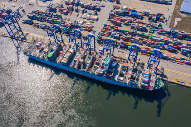istock Container ship from sea port working for delivery containers shipment and container warehouse background. Suitable use for transport or import export to global logistics concept. 1268682462