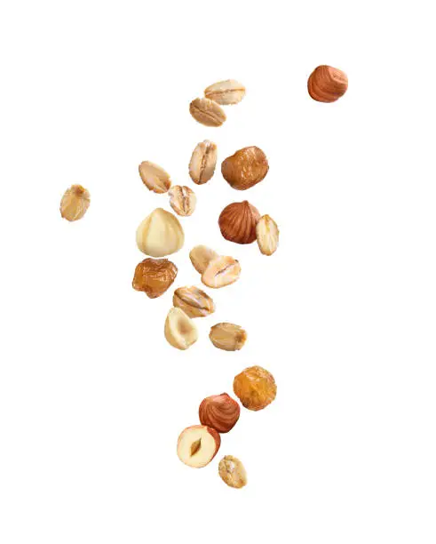 Photo of oatmeal with nuts and raisins on a white background
