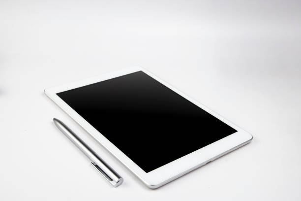 There is an tablet computer and a pen on the white background