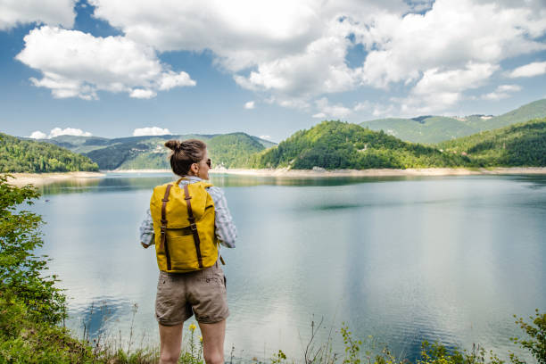 istock A woman with a backpack in the nature 1268683255