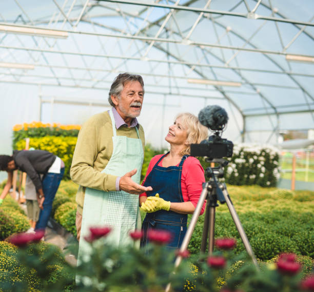 istock Two senior adults vlogging in a greenhouse 1268685968