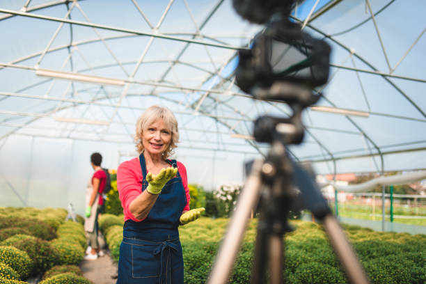 istock Mature woman vlogging in a greenhouse 1268685980