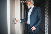Businessman using a keyless entry card to enter his hotel room