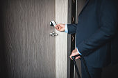 Close up of a  businessman using a keyless entry card to enter his hotel room
