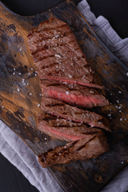 istock Sliced beef steak seasoned with salt on cutting board 1268687687