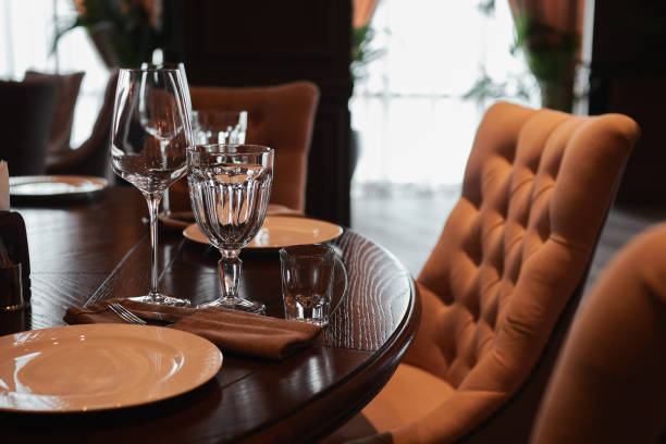 istock Glass goblets for dinner in a dark restaurant interior 1268689859