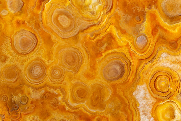 istock Full-screen macro image of yellow agate with a spherolite-concentric structure from the Moscow region. Natural stone background. 1268690096