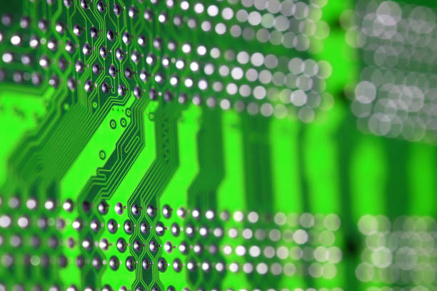 istock Full screen close up texture of a green PCB with selective focus and bokeh background 1268690130