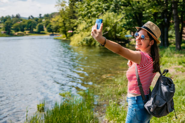 istock Woman making selfie by the lake 1268690286