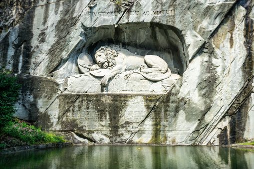 Scenic view of the Lucerne Lion monument carving and pool symbol of Lucerne city Switzerland ( translation : To the loyalty and bravery of the Swiss )