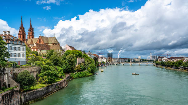 Basel panoramic cityscape with Rhine river view colourful old town and industrial buildings in the distance in Basel Switzerland Basel panoramic cityscape with Rhine river view colourful old town and industrial buildings in the distance in Basel Switzerland basel switzerland photos stock pictures, royalty-free photos & images