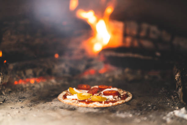 istock Small gluten-free pizza inside a pizza oven 1268691636
