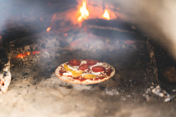 istock Small gluten-free pizza inside a pizza oven 1268691655