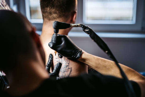 istock Artist tattooing a man in studio 1268692743