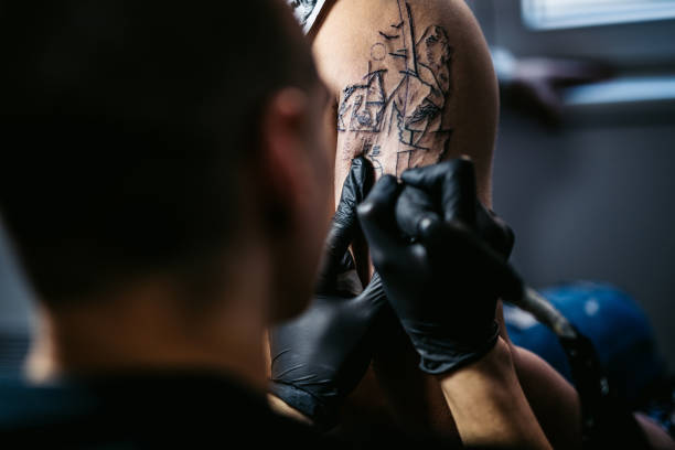 istock Artist tattooing a man in studio 1268693103