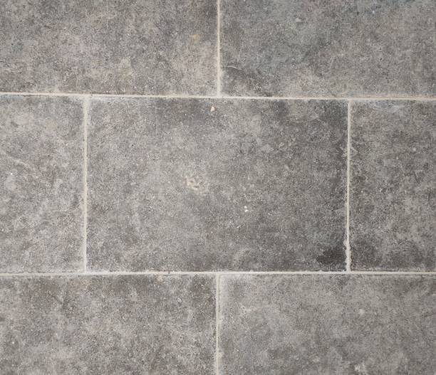 istock Tumbled weathered natural stone tile texture for exterior flooring 1268696509