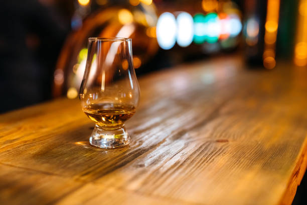 istock Glass of whiskey on bar counter 1268696519