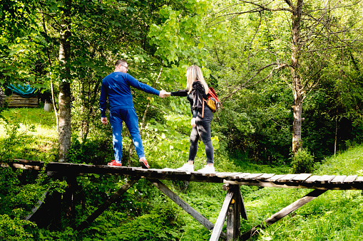 Follow me. Travel concept. Young woman holding boyfriend's hand