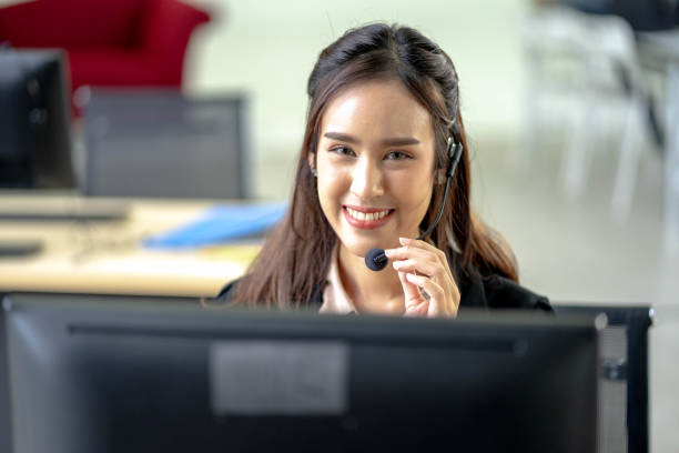 istock Portrait of happy smiling female customer support phone operator at workplace. Professional operator concept. 1268698461