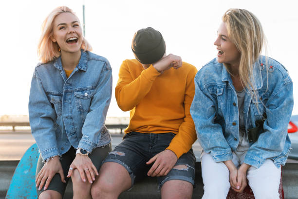 istock Three positive friends are laughing on a street 1268700653