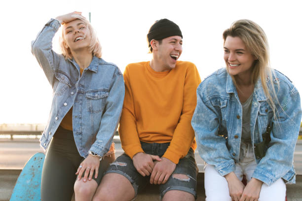 istock Three positive friends are laughing on a street 1268700680