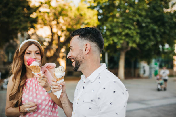 istock Couple walking and enjoying ice cream 1268703171