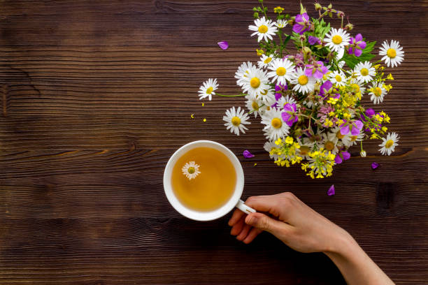 istock Wild flowers with herbal tea on a table top view, copy space 1268703751