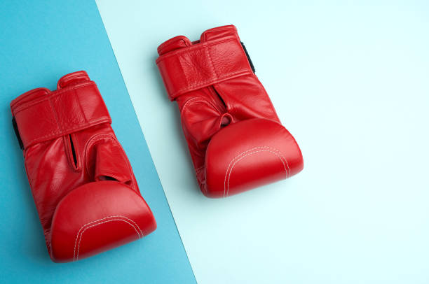 istock pair of red leather boxing gloves on a blue background 1268707630