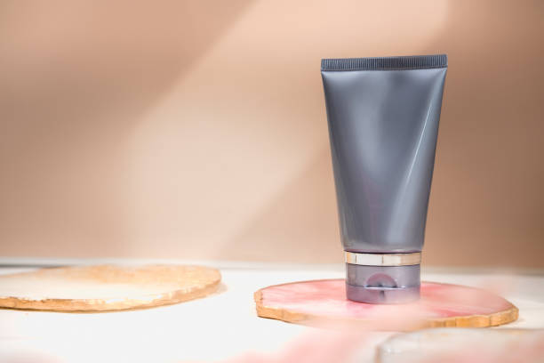 istock Grey cosmetic tube on neutral pastel nude background 1268711133