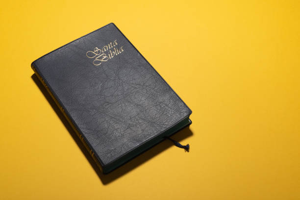 istock Santa Biblia (Holy Bible in spanish) over mustard yellow desk 1268712456