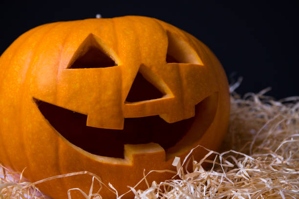 istock Halloween pumpkin Jack-O-Lantern with happy face over grey 1268716124