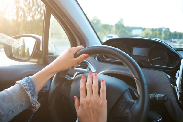 istock Women's hands on the wheel. Cars interior 1268724393