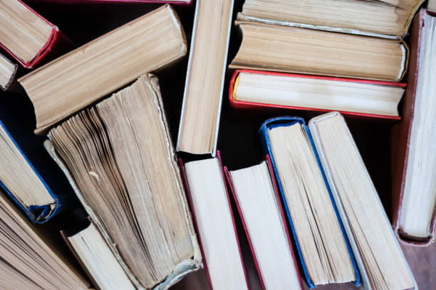 istock stack of old book, education concept background, many books piles with copy space for text 1268725028