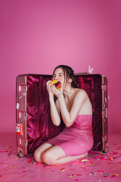Concept of Asian woman with unhealthy eating Concept of Asian woman with unhealthy eating Models EATING stock pictures, royalty-free photos & images