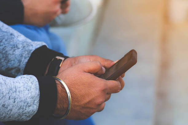 istock Hand of man holding a modern smart phone 1268726397