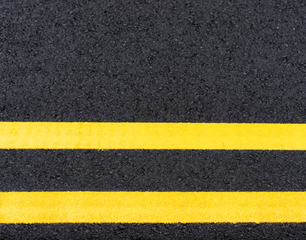 istock Double yellow lines on new asphalt 1268726564