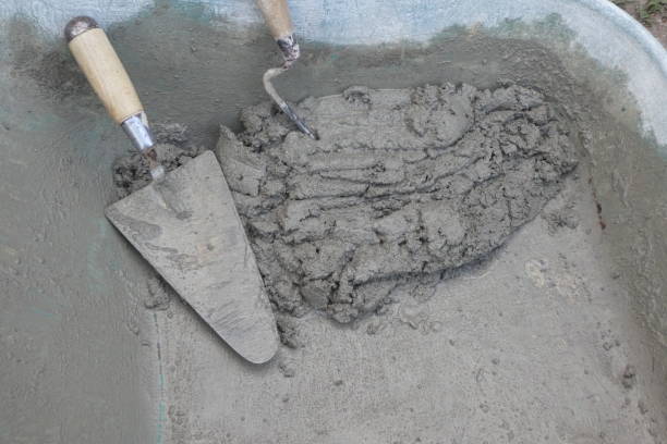 istock small amount of cement with trowels 1268726587