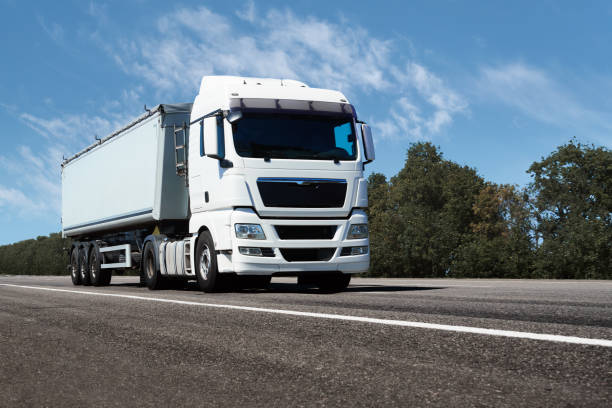 istock truck on the road, front view, empty space on a white container - concept of cargo transportation, trucking industry 1268729088