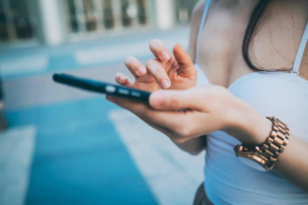 istock Young Asian woman using phone 1268729229