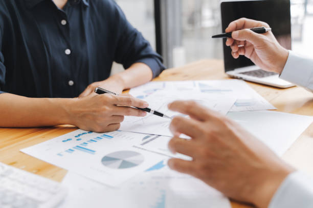 istock Financial inspector calculating a numbers in office room. 1268731604