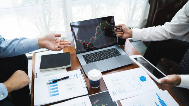 istock Two businessman discuss stock trading information. 1268731609