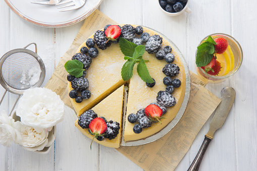 Blueberry mousse cake, cheesecake with fresh blueberry on white plate with mint leaves