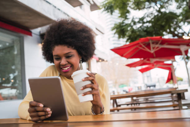 istock Afro american latin woman using digital tablet 1268733341