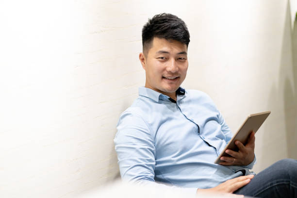 istock Man holding a tablet and looking into the camera 1268733647
