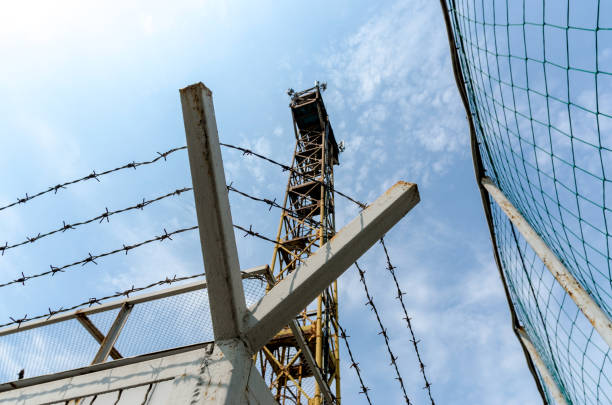 istock fence barbed wire and watchtower on the border Ukraine 1268739617