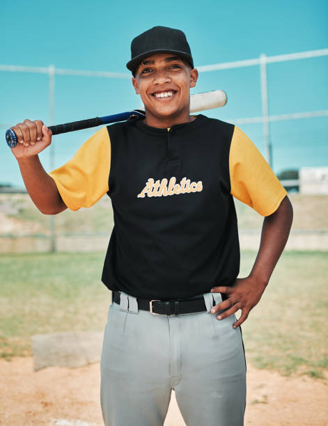 I'm playing like a champion today Shot of a young baseball player holding a baseball bat while posing outside on the pitch baseball pitcher baseball player baseball diamond stock pictures, royalty-free photos & images