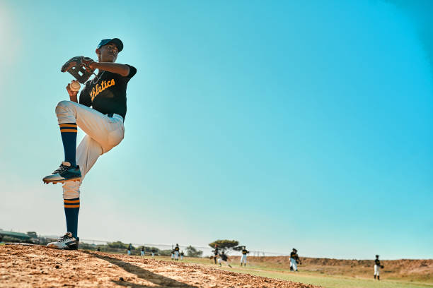 Get ready! Shot of a young baseball player pitching the ball during a game outdoors pro baseball player stock pictures, royalty-free photos & images