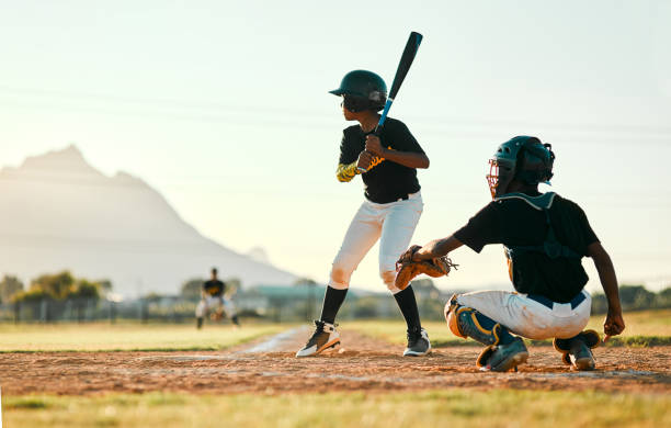 Waiting for his opportunity to swing Shot of two baseball players in position during a game batting sports activity stock pictures, royalty-free photos & images