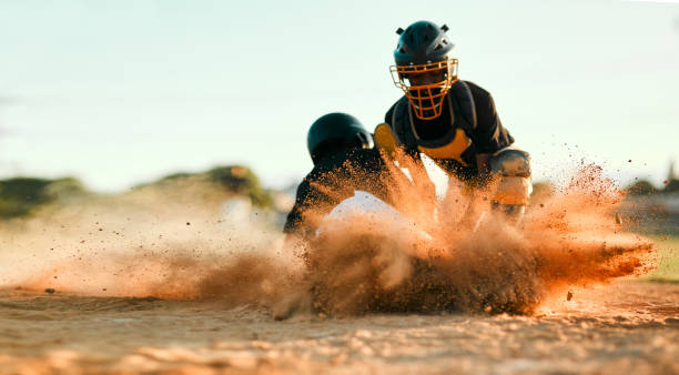 Keep trying until you get it! Shot of a baseball player sliding to the base during a baseball game baseball pitcher baseball player baseball diamond stock pictures, royalty-free photos & images